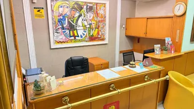 an office with a desk with a clock on the wall at Hotel Concorde in Rome
