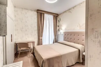 a hotel room with a bed and a desk at Hotel Milo in Rome