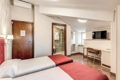 a hotel room with a bed and a desk at Hotel Milo in Rome