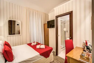 a hotel room with a bed and a mirror at Auditorium Mecenate in Rome