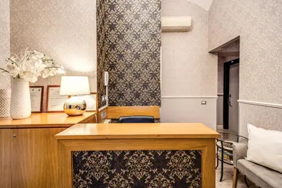 a room with a desk with a lamp and a chair at Auditorium Mecenate in Rome