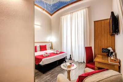 a hotel room with a bed and a living room at Auditorium Mecenate in Rome