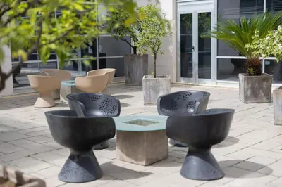 a group of chairs and tables in front of a building at Precise House Mantegna Roma in Rome