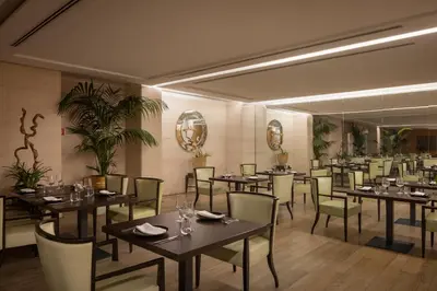 a dining room with tables and chairs and mirrors at Precise House Mantegna Roma in Rome