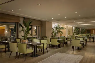 a restaurant with tables and chairs in a room at Precise House Mantegna Roma in Rome