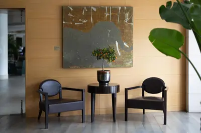 two chairs and a table with a potted plant on it at Precise House Mantegna Roma in Rome