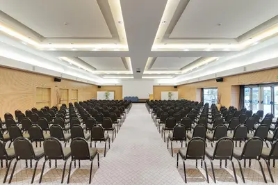 an empty room with rows of chairs in it at Precise House Mantegna Roma in Rome