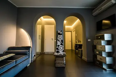 a hallway with arches and a room with a bed at Il Covo B&B in Rome