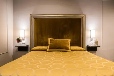 a bedroom with a large bed with a large headboard at Il Covo B&B in Rome