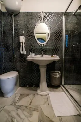 a bathroom with a sink and a shower and a mirror at Il Covo B&B in Rome
