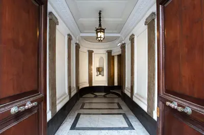 a hallway in a building with a chandelier at Tourist House B&B in Rome