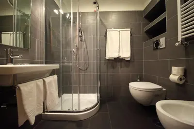 a bathroom with a shower and a toilet and a sink at Tourist House B&B in Rome
