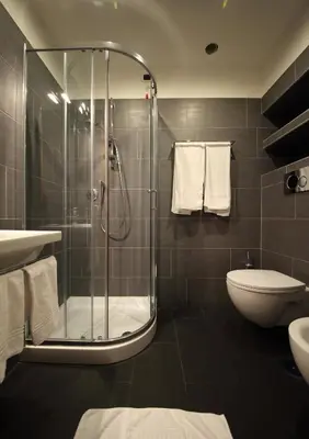 a bathroom with a shower and a toilet and a sink at Tourist House B&B in Rome