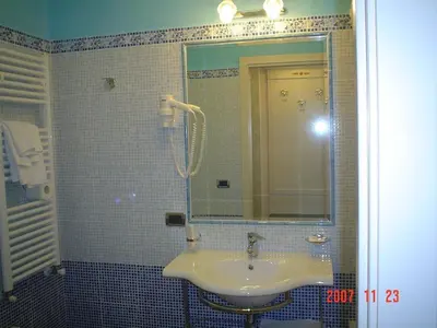 a bathroom with a sink and a mirror at Hotel Dina in Rome