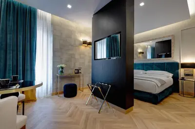 a hotel room with a bed and a desk at Dharma Boutique Hotel & SPA in Rome