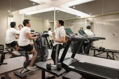a group of people running on treadles in a gym at Dharma Boutique Hotel & SPA in Rome