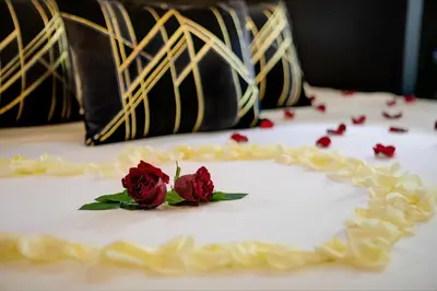 a white cake with two roses on top of it at Dharma Boutique Hotel & SPA in Rome