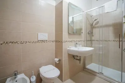 a bathroom with a toilet and a sink and a shower at Hotel St. Moritz in Rome