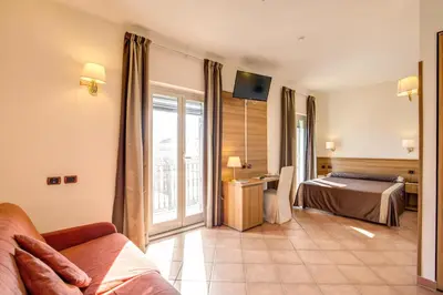 a hotel room with a bed and a balcony at Hotel San Marco in Rome