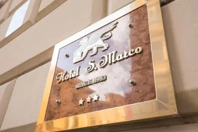a sign for auld soliloquy on a building at Hotel San Marco in Rome