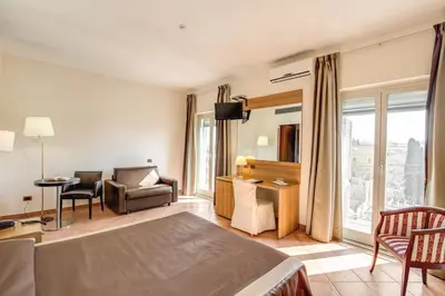 a hotel room with a bed and a living room at Hotel San Marco in Rome