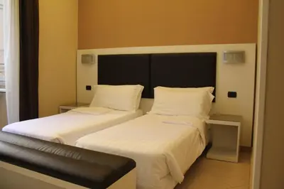 two beds sitting next to each other in a room at Hotel San Marco in Rome