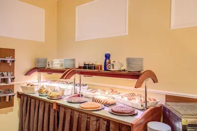 a buffet line with donuts and other pastries at Hotel San Marco in Rome
