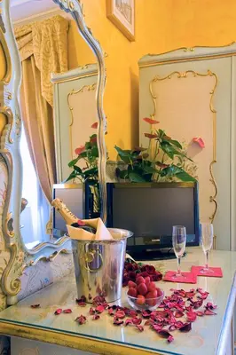 a table with a bowl of fruit and a tv at Hotel Villa San Lorenzo Maria in Rome