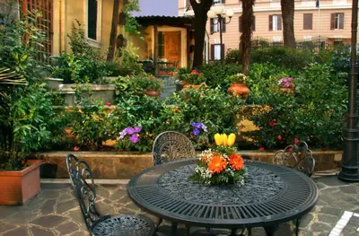 a table and chairs with flowers on top of it at Hotel Villa San Lorenzo Maria in Rome