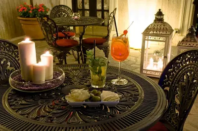 a table with candles and a plate of food on it at Hotel Villa San Lorenzo Maria in Rome