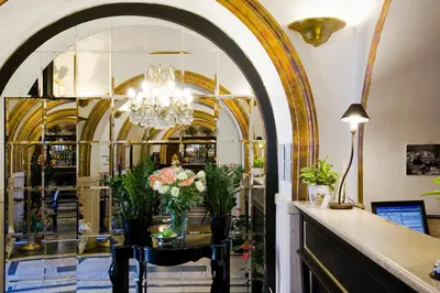 a lobby with a chandelier and a table with flowers at Hotel Villa San Lorenzo Maria in Rome