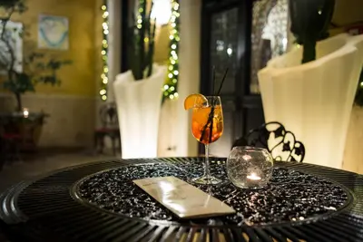 a table with two glasses and a candle on it at Hotel Villa San Lorenzo Maria in Rome