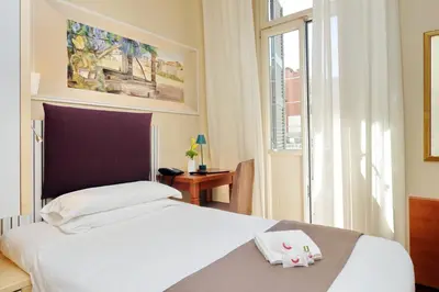 a hotel room with a bed and a window at Hotel Camelia in Rome