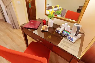 a desk in a hotel room with a mirror at Hotel Camelia in Rome