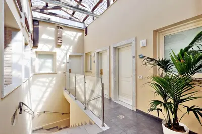 a hallway with stairs and a skylight at Hotel Camelia in Rome