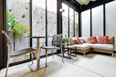 a living room with a couch and a table and chairs at Hotel Camelia in Rome