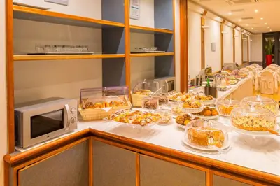 a buffet with many different types of food on a counter at Best Western Hotel Artdeco in Rome