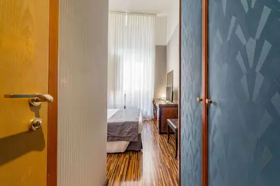 a room with a bedroom with a bed and a door at Best Western Hotel Artdeco in Rome