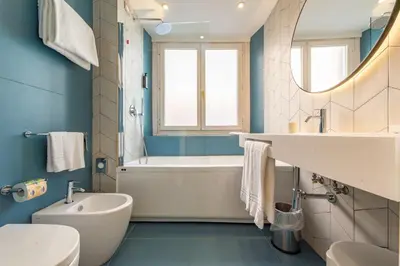 a bathroom with a tub and a sink and a toilet at Best Western Hotel Artdeco in Rome
