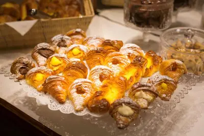 a bunch of pastries on a plate on a table at Best Western Hotel Artdeco in Rome