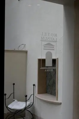 a room with two chairs and a sign on the wall at Hotel Latinum in Rome