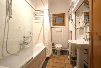 a bathroom with a shower and a toilet and a sink at Hotel Locanda Cairoli in Rome