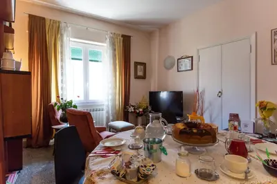 a living room with a table with a cake on it at B&B Anni 50 in Rome