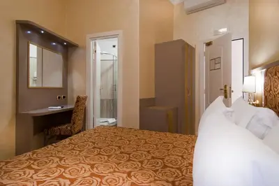 a hotel room with a bed and a bathroom at Hotel Fellini a Fontana di Trevi in Rome