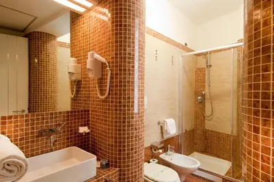 a bathroom with a toilet and a sink and a shower at Hotel Fellini a Fontana di Trevi in Rome