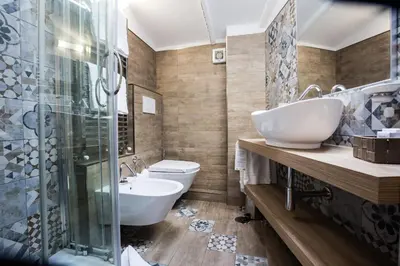 a bathroom with two sinks and a shower and a toilet at Hotel Fellini a Fontana di Trevi in Rome