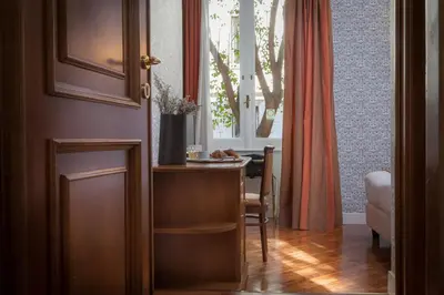 a dining room with a table and a window at Suite Beccaria A Piazza Del Popolo in Rome