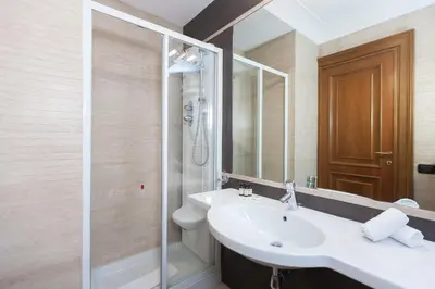 a bathroom with a sink and a shower at Suite Beccaria A Piazza Del Popolo in Rome