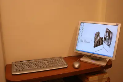 a computer monitor and a keyboard and mouse on a desk at Suite Beccaria A Piazza Del Popolo in Rome