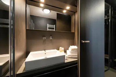 a bathroom with a white sink and a mirror at Coronari Palace in Rome